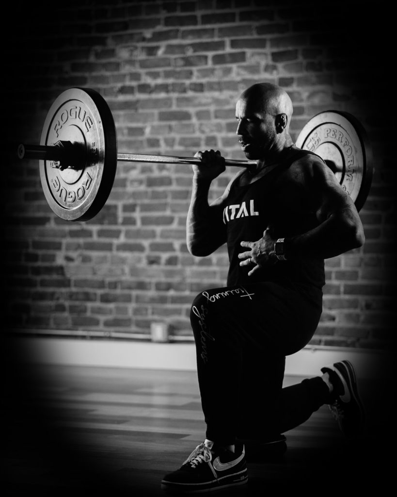 Vital Training Systems coach Vinnie doing barbell lunges with rogue echo plates